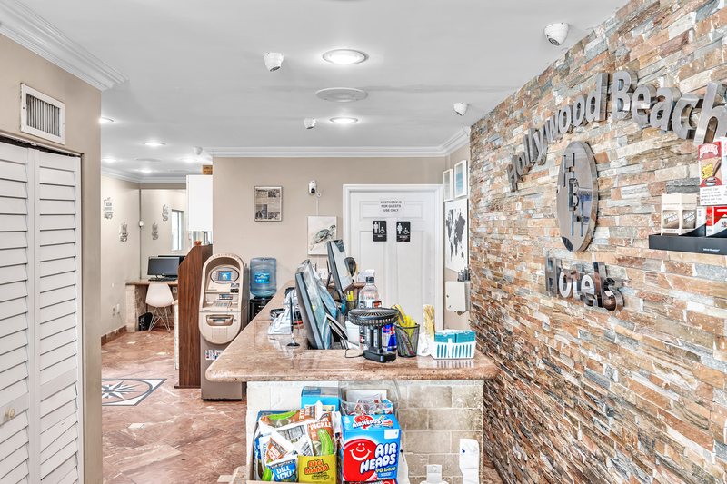 The front desk inside the Seagull, the stone wall with the Hollywood Beach Hotels sign